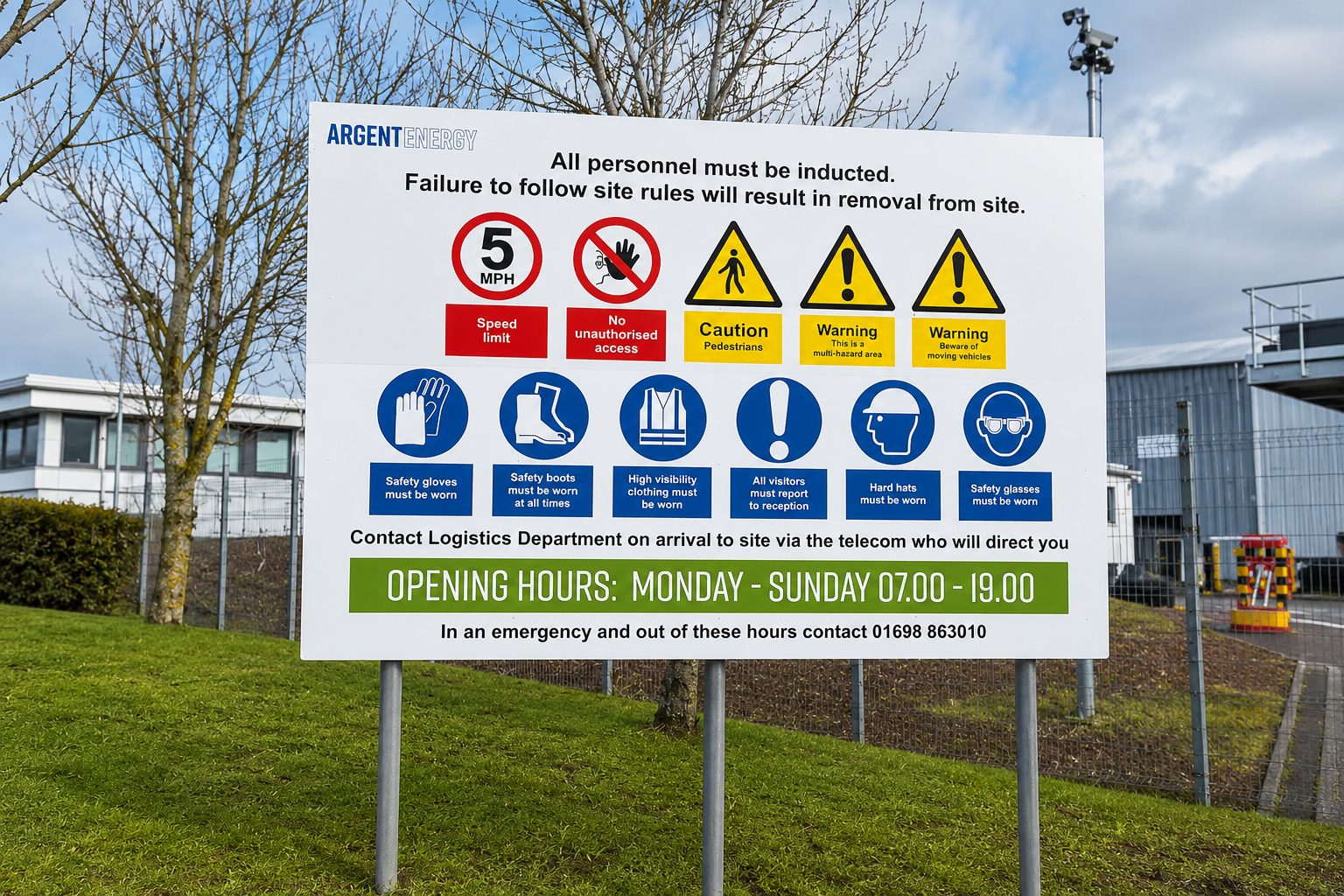 Large white safety sign at an industrial site listing rules, PPE requirements, warnings, and opening hours (ARGENT ENERGY).