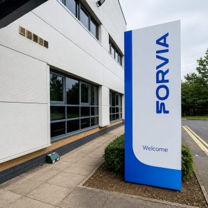 Exterior of a modern office building with a large vertical sign reading SORVIA and a wall-mounted Reception sign.