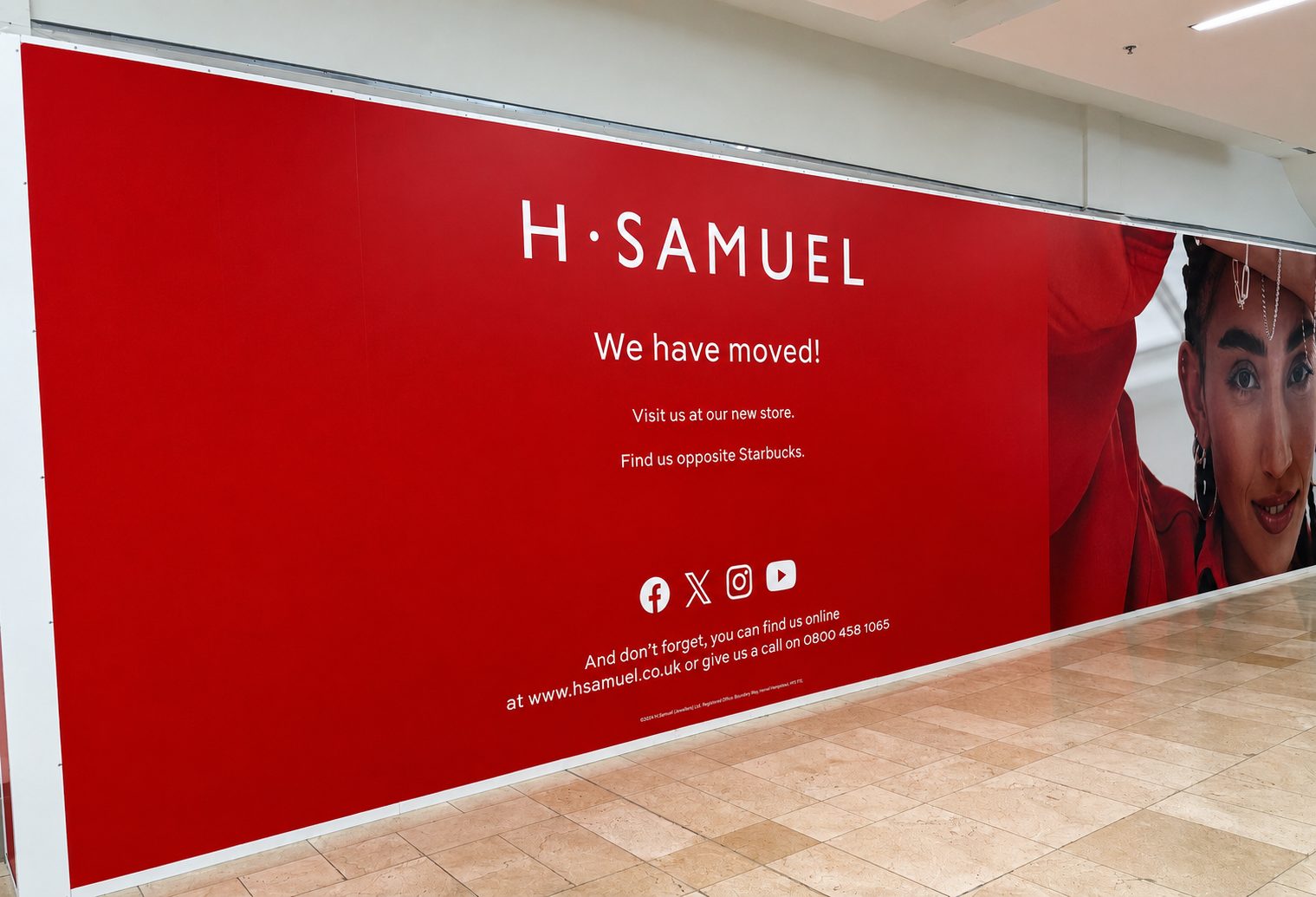 H. Samuel red banner announcing the move: 'We have moved!' with directions to visit the new store and find us online in a mall corridor.