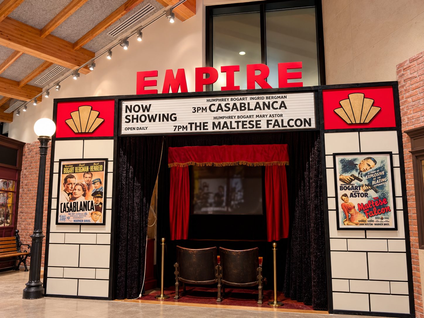 The Empire cinema facade with red letters, vintage marquee showing Casablanca and The Maltese Falcon, red curtains open to a small stage.