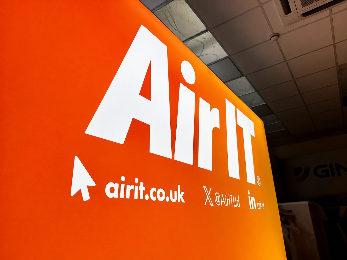 Large orange sign with white 'AirIt' logo and the URL airit.co.uk, promoting AirIt Ltd.