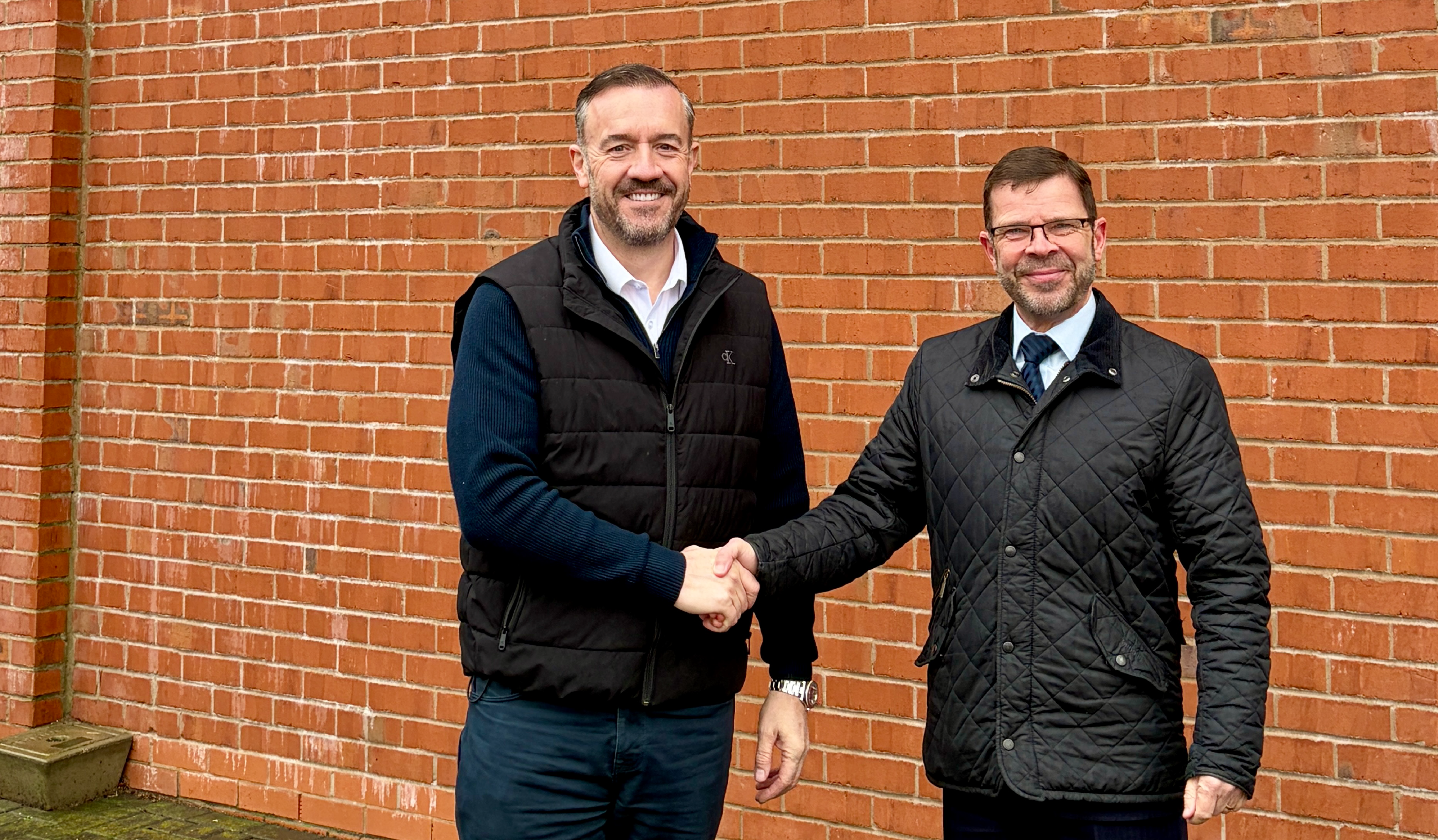 Nik Hardy and Dale Bywater from Burton Kia shaking hands