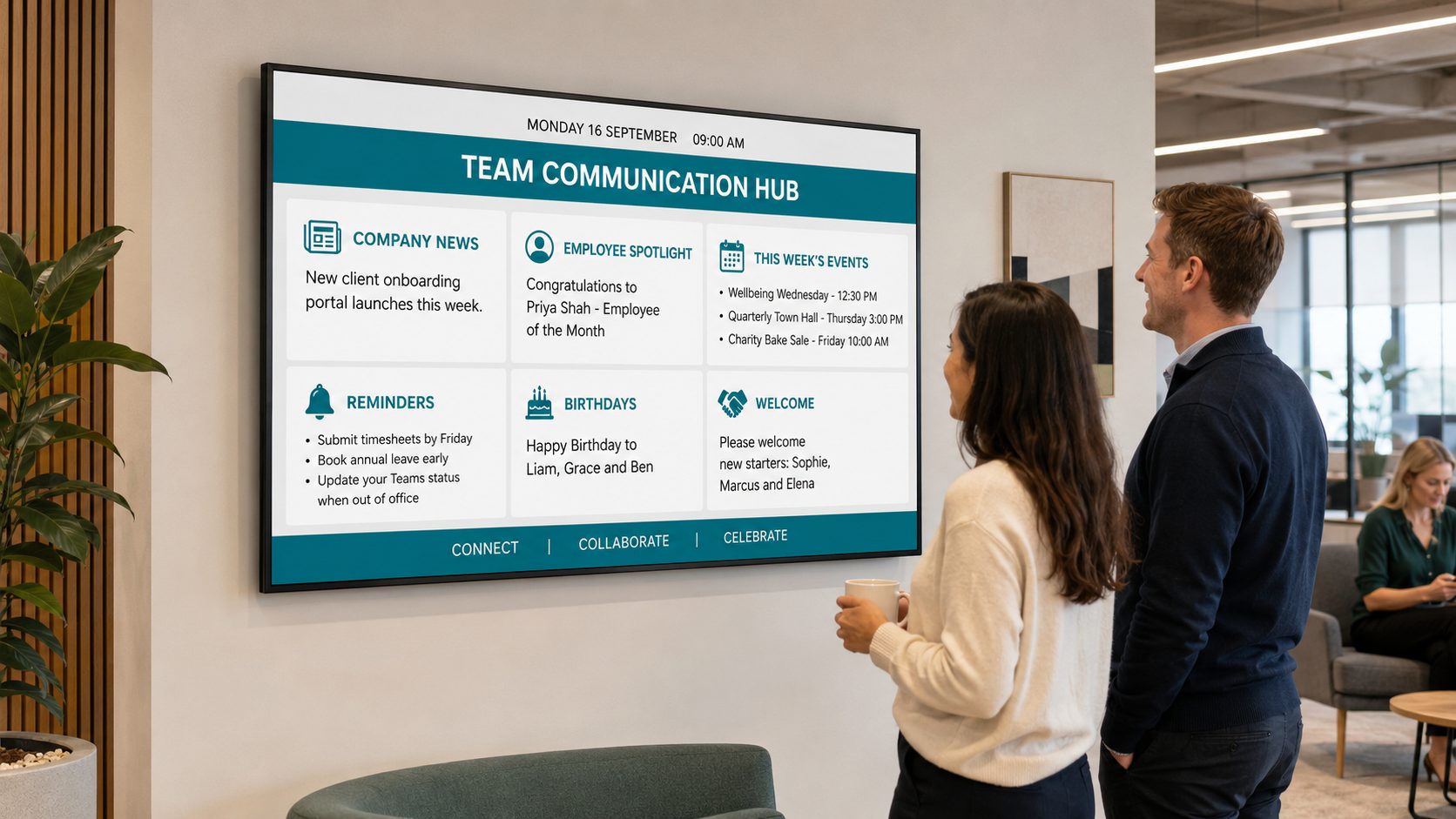 Two colleagues stand by a wall-mounted screen labeled 'Team Communication Hub' displaying company notices in a modern office.